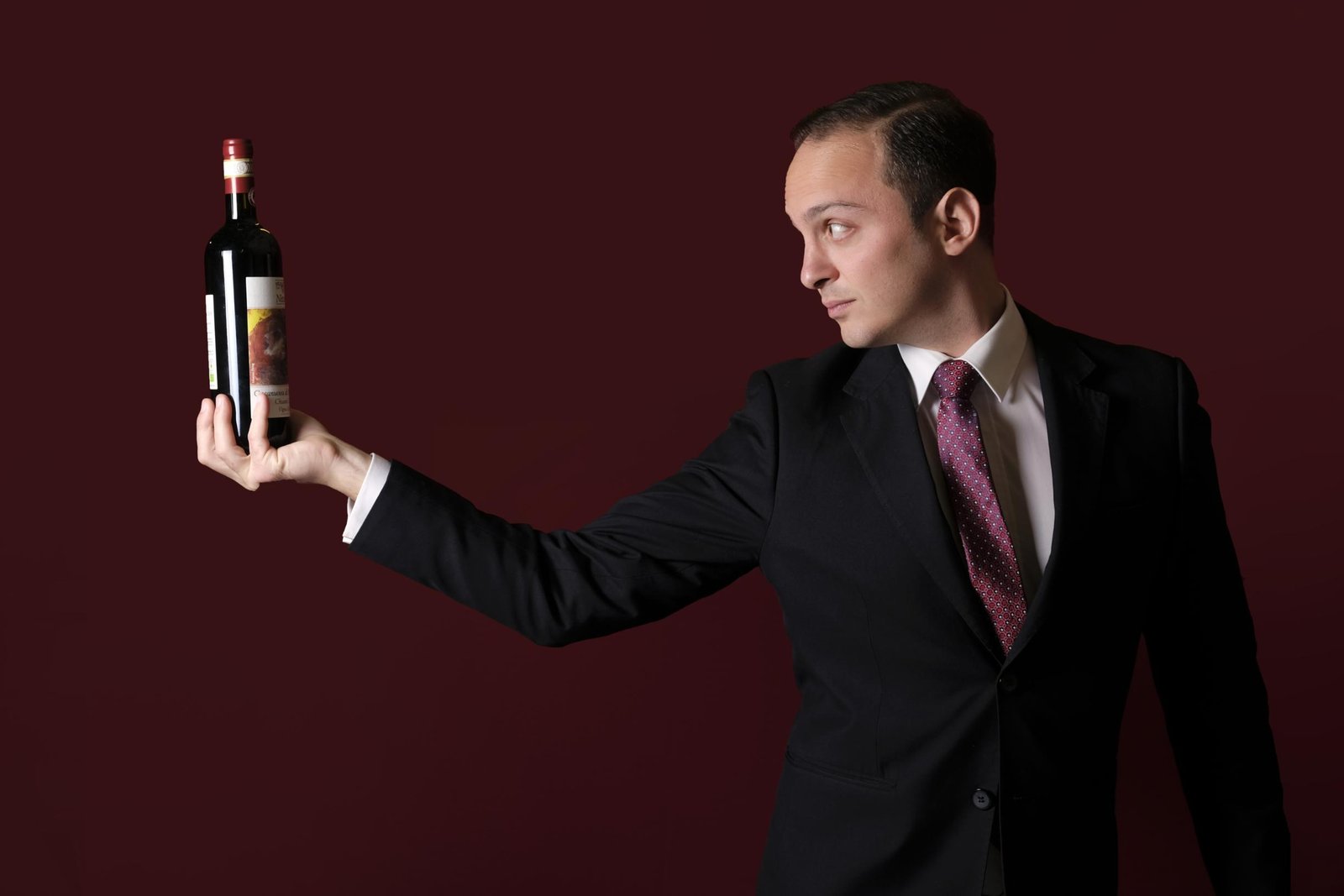 MTTIA holding a bottle of wine